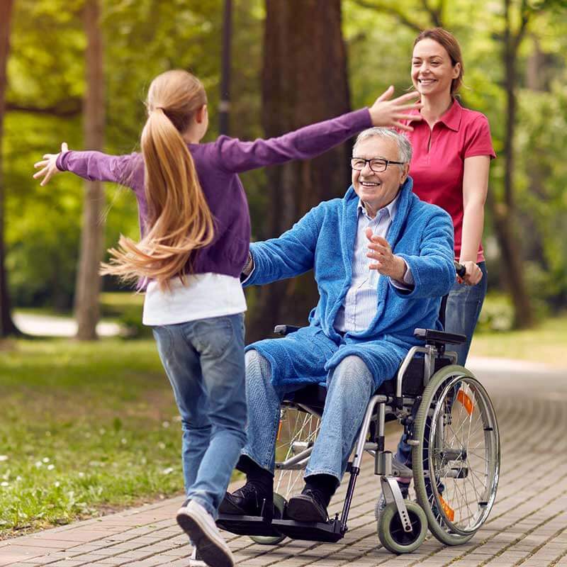 child running to grandpa in wheelchair